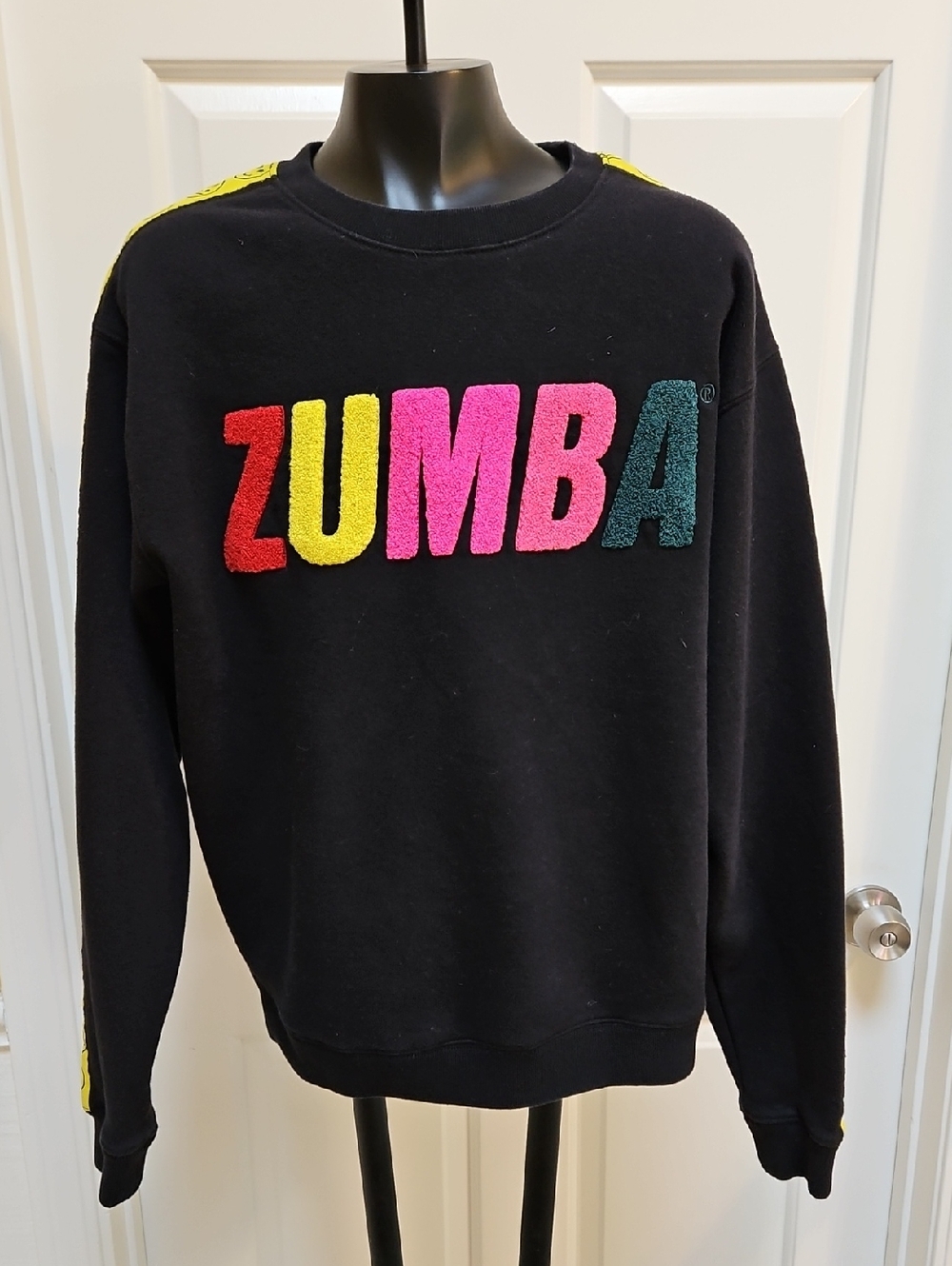 ZUMBA Fitness black sweatshirt featuring raised, Colorful rainbow lettering - M